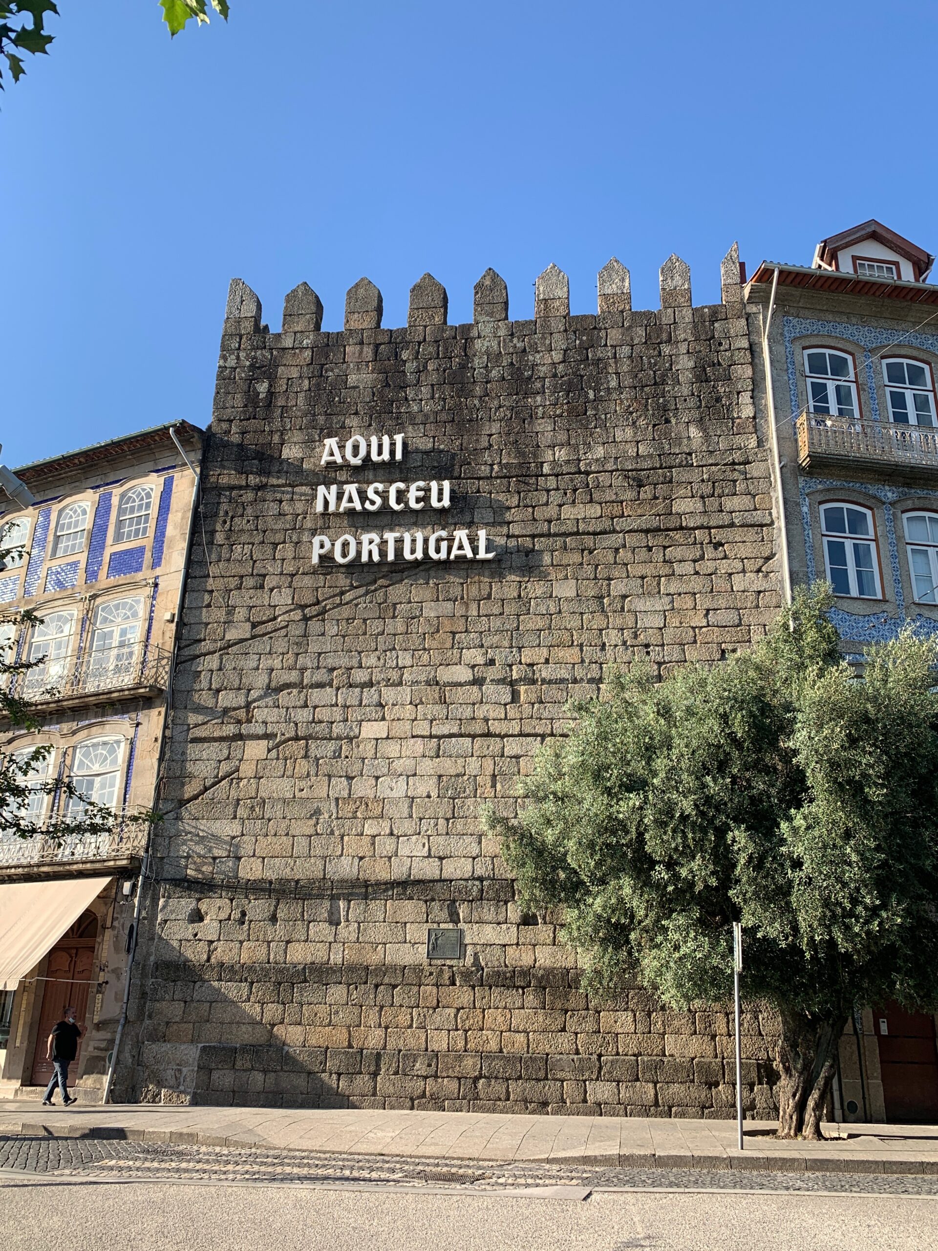 View of Guimarães medieval city wall with lettering stating that 'Portugal was born here', in reference to the city being Afonso Henrique's birthplace.